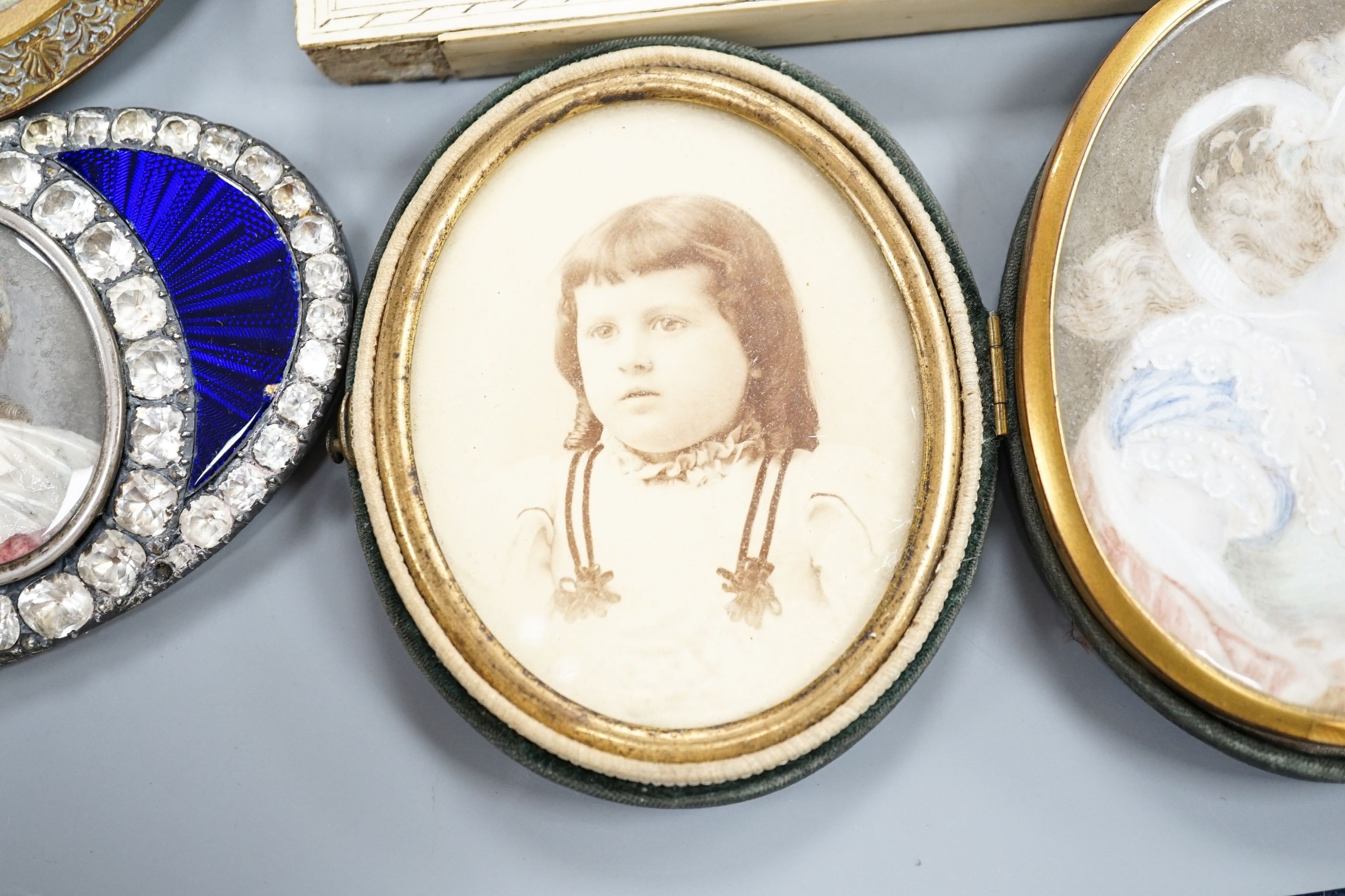 A paste and enamel framed Portrait miniature on ivory, 9.2cm and four other portrait miniatures (three on ivory)